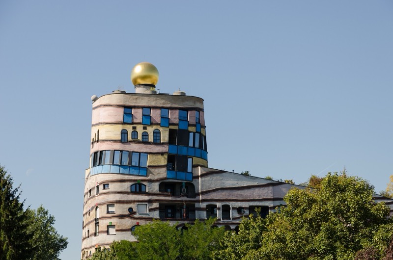 Turm der Waldspirale von Friedensreich Hundertwasser in Darmstadt mit goldener Kuppel, bunten Fenstern und geschwungenen Fassadenbändern